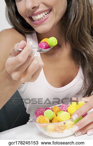 Close-up of a woman eating cereal View Large Photo Image Stock Image - Close-up of a woman eating cereal. Fotosearch