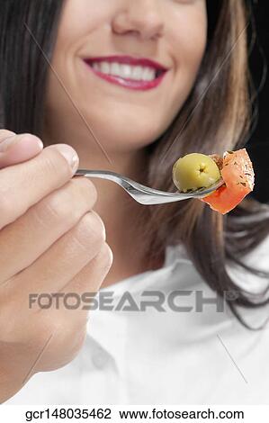 Close-up of a woman eating salad View Large Photo Image Stock Image - Close-up of a woman eating salad. Fotosearch