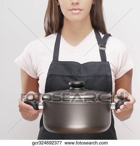 Close-up of a woman holding a crock pot View Large Photo Image Stock Photo - Close-up of a woman holding a crock pot. Fotosearch