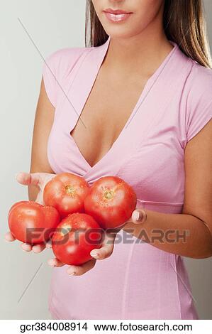 Close-up of a woman holding tomatoes View Large Photo Image Picture - Close-up of a woman holding tomatoes. Fotosearch
