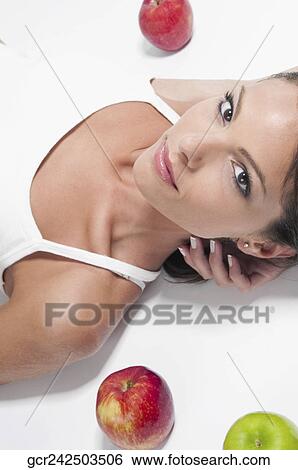 Close-up of a woman lying with red and green apples View Large Photo Image Stock Photograph - Close-up of a woman lying with red and green apples. Fotosearch