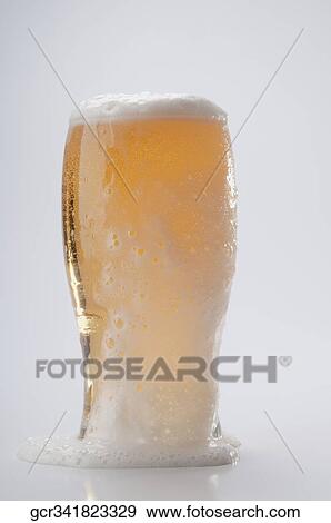 Close-up of an overflown beer glass View Large Photo Image Stock Photo - Close-up of an overflown beer glass. Fotosearch