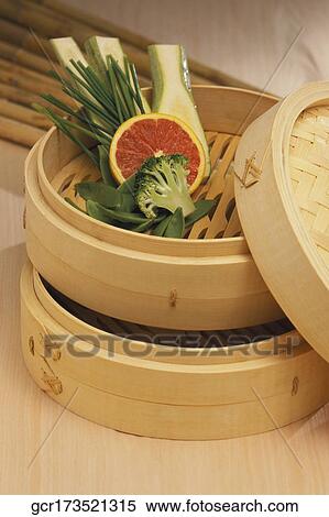 Stock Photography - Close-up of assorted vegetables in a bamboo steamer. Fotosearch