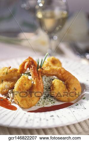 Stock Photo - Close-up of batter fried prawns served with rice. Fotosearch