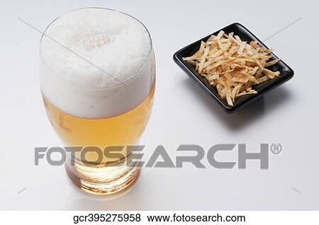 Close-up of beer and chips View Large Photo Image Stock Photo - Close-up of beer and chips. Fotosearch