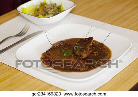 Close-up of braised meat on a dish View Large Photo Image Stock Image - Close-up of braised meat on a dish. Fotosearch