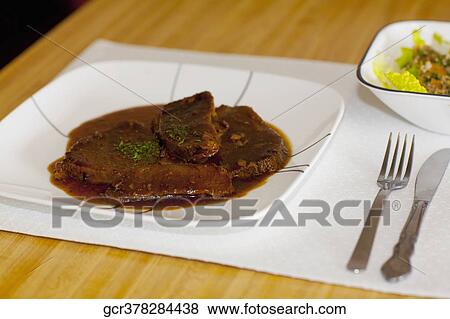 Close-up of braised meat on a dish View Large Photo Image Stock Photo - Close-up of braised meat on a dish. Fotosearch
