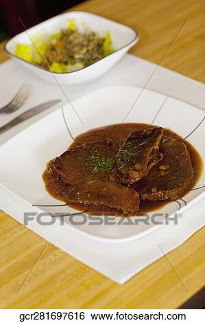 Close-up of braised meat on a dish View Large Photo Image Stock Photograph - Close-up of braised meat on a dish. Fotosearch
