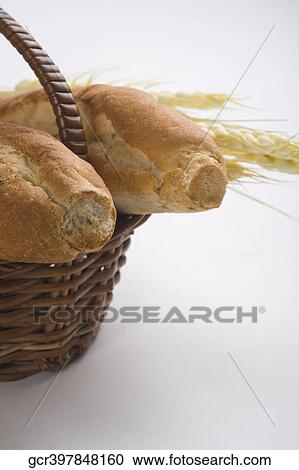 Close-up of bread with ears of wheat in wicker basket View Large Photo Image Stock Image - Close-up of bread with ears of wheat in wicker basket. Fotosearch