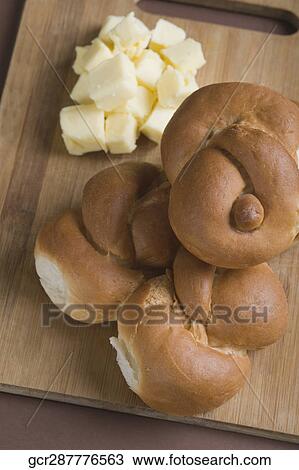Close-up of breads and butter on cutting board View Large Photo Image Stock Image - Close-up of breads and butter on cutting board. Fotosearch