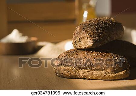 Close-up of breads with a bowl of flour View Large Photo Image Stock Photograph - Close-up of breads with a bowl of flour. Fotosearch