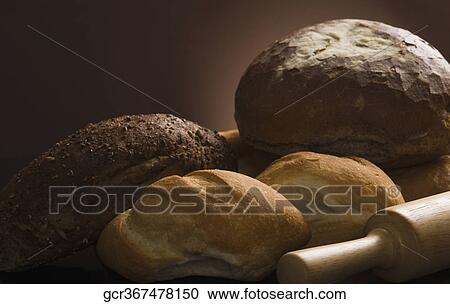 Stock Image - Close-up of breads with a rolling pin. Fotosearch