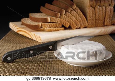 Close-up of Brie served with bread View Large Photo Image Stock Photo - Close-up of Brie served with bread. Fotosearch