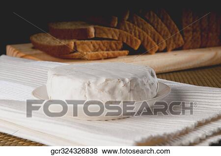 Stock Photo - Close-up of brie served with breads. Fotosearch