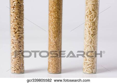 Close-up of brown rice and sugar with wheat in test tubes View Large Photo Image Stock Image - Close-up of brown rice and sugar with wheat in test tubes. Fotosearch