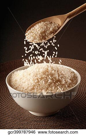 Stock Photograph - Close-up of brown rice in a ceramic bowl. Fotosearch