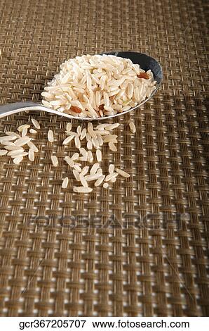 Close-up of brown rice on a spoon View Large Photo Image Stock Photo - Close-up of brown rice on a spoon. Fotosearch