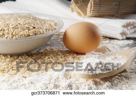 Close-up of brown rice with flour and an egg View Large Photo Image Stock Image - Close-up of brown rice with flour and an egg. Fotosearch