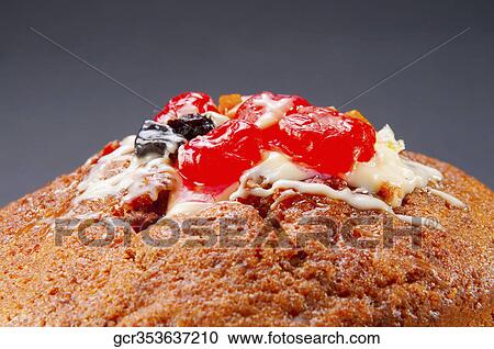 Stock Image - Close-up of candied fruit on cake. Fotosearch