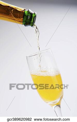Close-up of champagne pouring into a glass View Large Photo Image Stock Image - Close-up of champagne pouring into a glass. Fotosearch