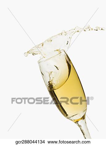 Picture - Close-up of champagne splashing in a champagne flute. Fotosearch