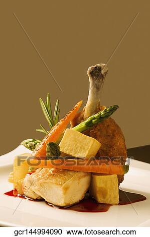 Close-up of chicken chop served with fish and asparagus on a platter View Large Photo Image Stock Image - Close-up of chicken chop served with fish and asparagus on a platter . Fotosearch
