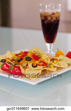 Stock Photo - Close-up of chips topped with peppers and olives. Fotosearch