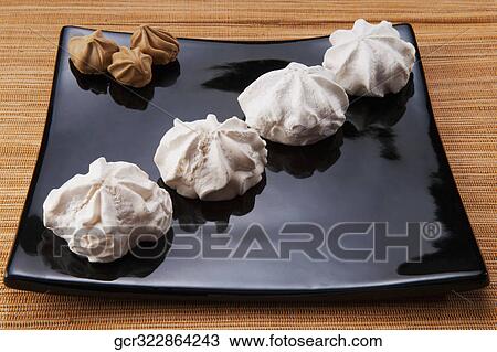 Close-up of chocolate and cream meringues on a platter View Large Photo Image Stock Image - Close-up of chocolate and cream meringues on a platter. Fotosearch