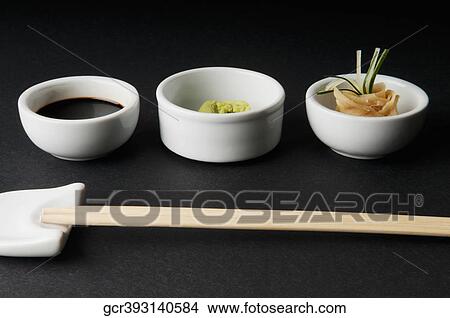 Close-up of chopsticks with soy sauce with wasabi paste and pickled ginger View Large Photo Image Picture - Close-up of chopsticks with soy sauce with wasabi paste and pickled ginger. Fotosearch