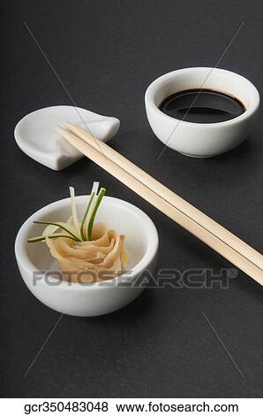 Close-up of chopsticks with soy sauce and pickled ginger View Large Photo Image Stock Photo - Close-up of chopsticks with soy sauce and pickled ginger. Fotosearch