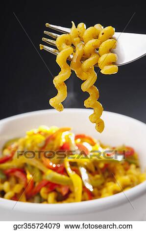 Stock Photo - Close-up of corkscrew pasta on a fork. Fotosearch
