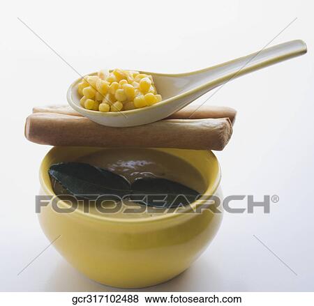 Stock Photo - Close-up of corn soup served with breadsticks. Fotosearch
