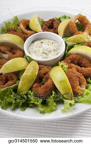 Stock Image - Close-up of crumb fried squid rings. Fotosearch