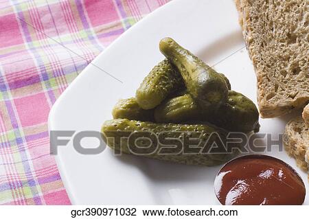Close-up of cucumber pickles and ketchup View Large Photo Image Stock Image - Close-up of cucumber pickles and ketchup. Fotosearch