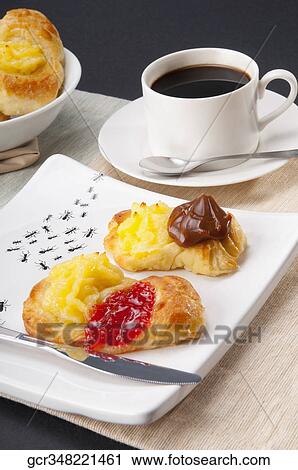 Close-up of danish pastries served with a cup of black coffee View Large Photo Image Stock Image - Close-up of danish pastries served with a cup of black coffee. Fotosearch