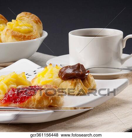 Close-up of danish pastries served with a cup of black coffee View Large Photo Image Stock Photo - Close-up of danish pastries served with a cup of black coffee. Fotosearch