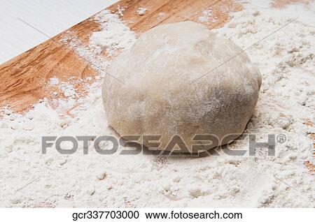 Close-up of dough on a cutting board View Large Photo Image Stock Image - Close-up of dough on a cutting board. Fotosearch