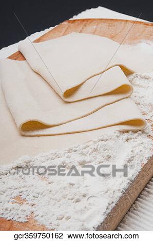 Close-up of dough on a cutting board View Large Photo Image Stock Image - Close-up of dough on a cutting board. Fotosearch