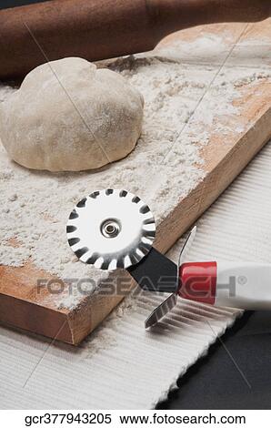 Close-up of dough with a rolling pin and pasta cutter View Large Photo Image Stock Photography - Close-up of dough with a rolling pin and pasta cutter. Fotosearch