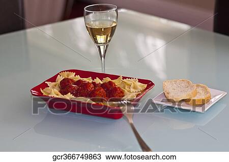 Stock Image - Close-up of farfalle pasta and meatballs. Fotosearch