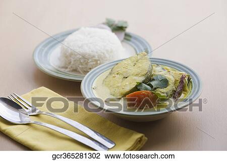 Close-up of fish curry served with rice View Large Photo Image Stock Image - Close-up of fish curry served with rice. Fotosearch