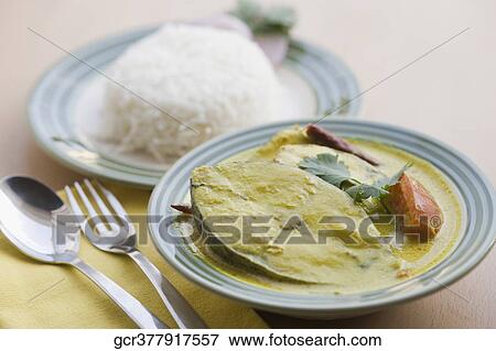 Close-up of fish curry served with rice View Large Photo Image Stock Photo - Close-up of fish curry served with rice. Fotosearch