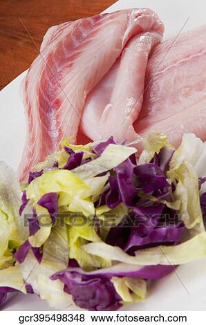Close-up of fish slices with red lettuce View Large Photo Image Stock Photo - Close-up of fish slices with red lettuce. Fotosearch