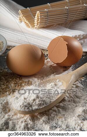 Stock Photograph - Close-up of flour and brown eggs. Fotosearch
