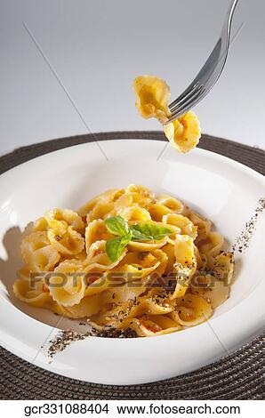 Close-up of fresh pepper and basil garnished pasta View Large Photo Image Picture - Close-up of fresh pepper and basil garnished pasta. Fotosearch