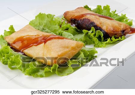 Close-up of fried dough pockets on lettuce View Large Photo Image Stock Photography - Close-up of fried dough pockets on lettuce. Fotosearch
