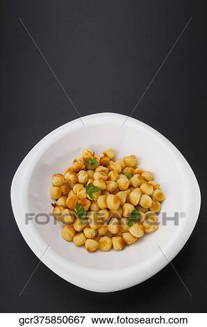 Stock Photo - Close-up of fritters garnished with parsley. Fotosearch