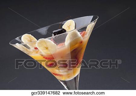 Stock Image - Close-up of fruit trifle in a martini glass. Fotosearch