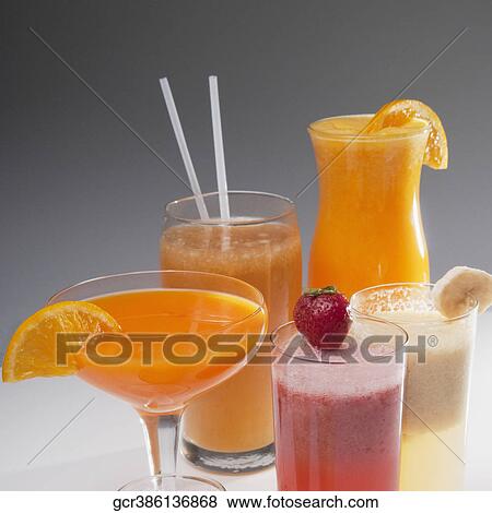 Close-up of glasses of fruit juice View Large Photo Image Stock Photo - Close-up of glasses of fruit juice. Fotosearch