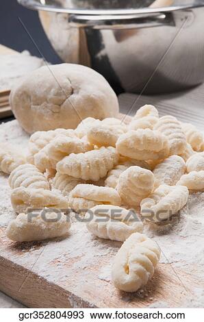 Close-up of gnocchi on a cutting board View Large Photo Image Stock Image - Close-up of gnocchi on a cutting board. Fotosearch